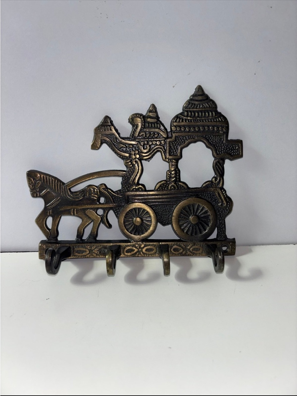 Vintage style decorative wall mounted key holder featuring a horse drawn